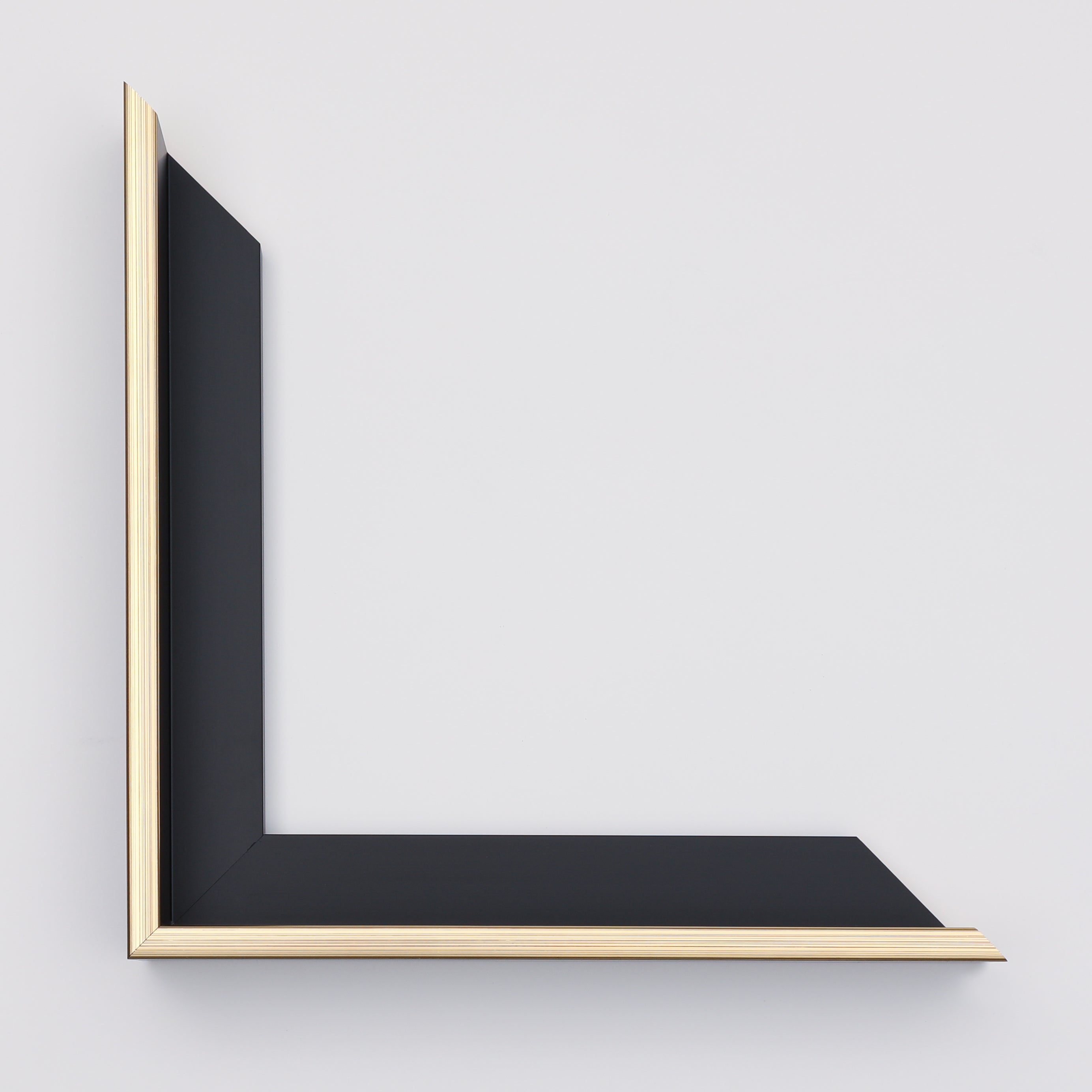 Black frame with gold border on a light gray background
