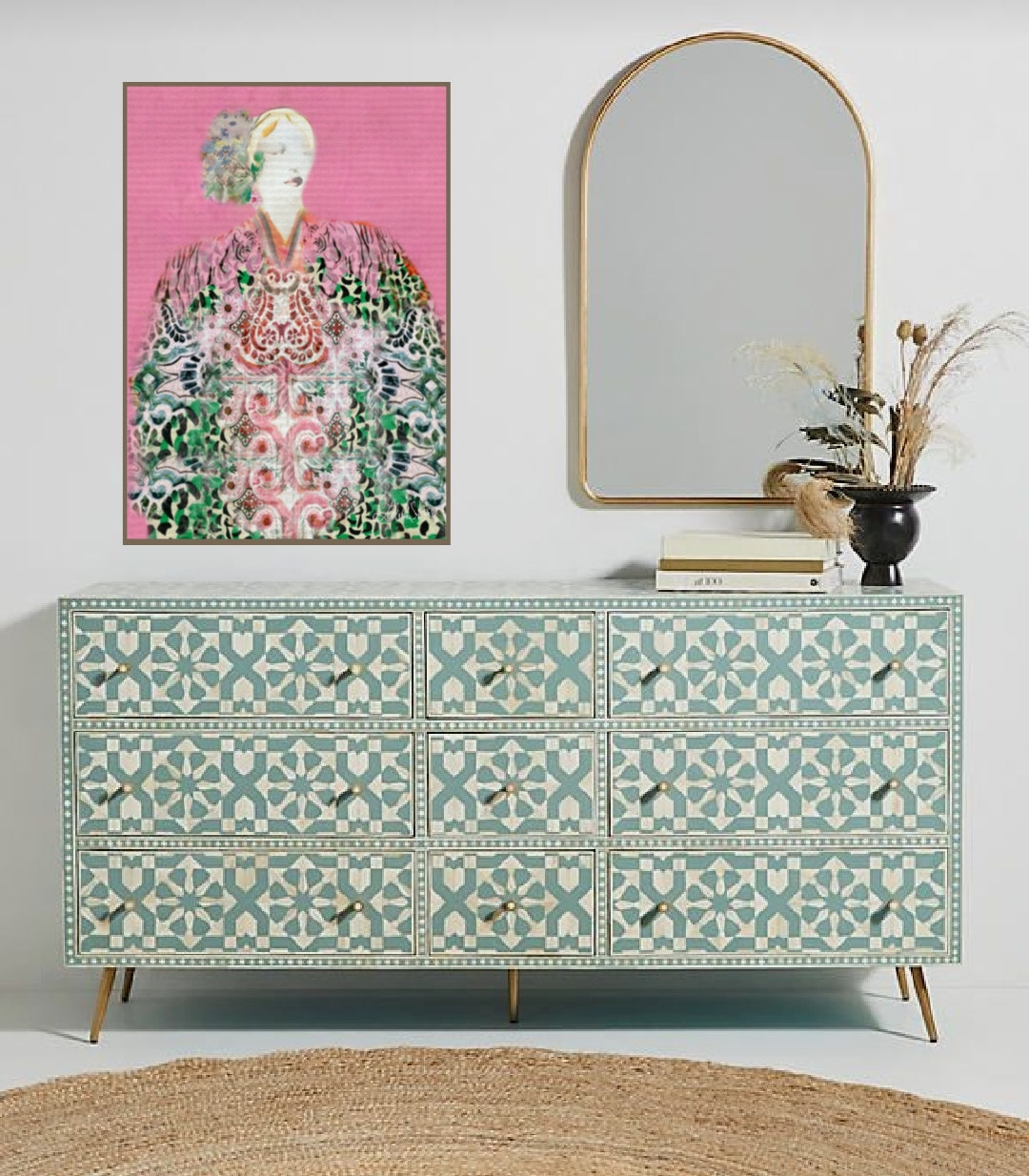 Patterned dresser with a mirror and  boho women artwork on a white wall