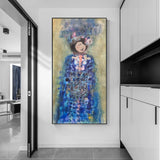 Colorful abstract painting of a woman in a blue dress on a white wall.