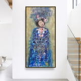 Framed chinese  figrative painting of a woman in a blue dress on a white wall.