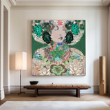 A large square wall art piece featuring an abstract floral and botanical portrait in green, teal, cream, and pink tones, displayed in a styled interior room above a wooden bench with a floor lamp and tall decorative objects.