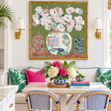 Chinoiserie canvas wall art in palm beach decor with chairs and a wicker pendant light in a bright, tropical-style room.